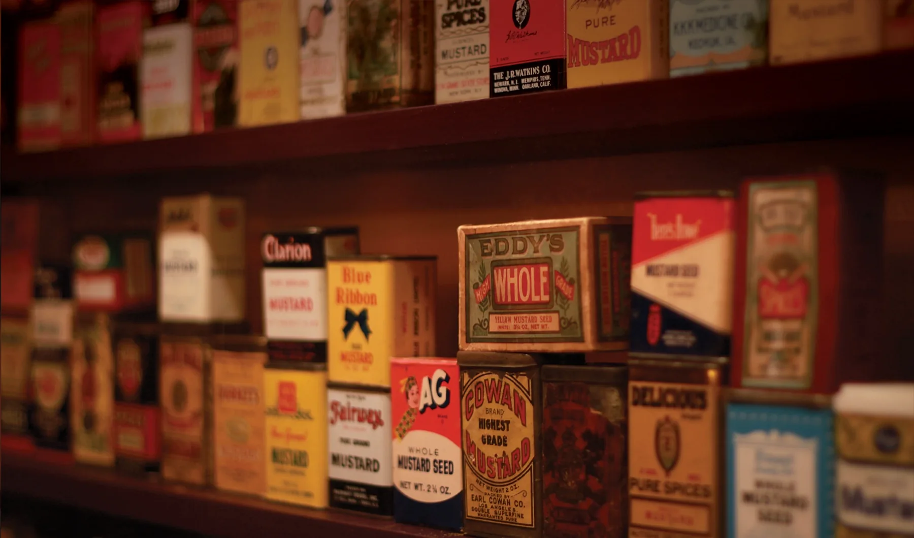 Antique mustard tins from the museum collection.
