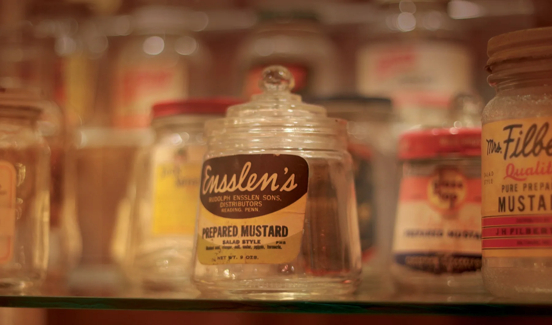 Vintage glass jars, including Ensslen’s prepared mustard.